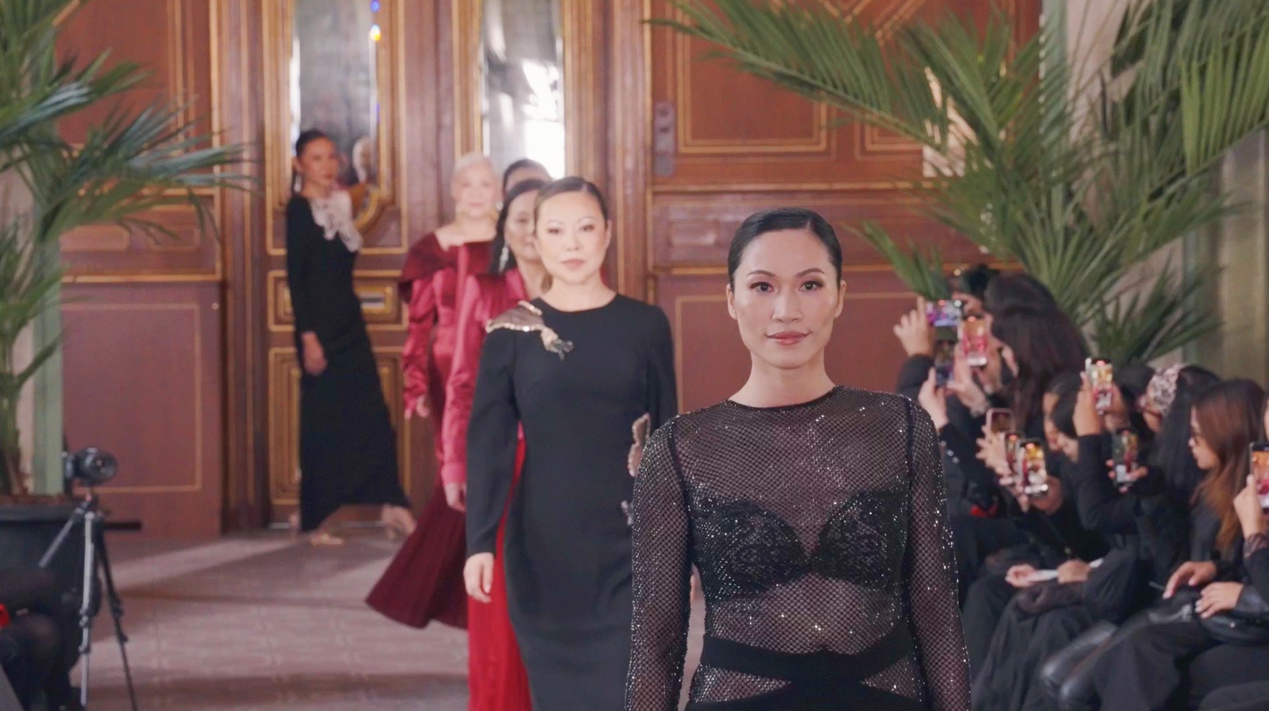 A group of women walking down the runway
Description automatically generated